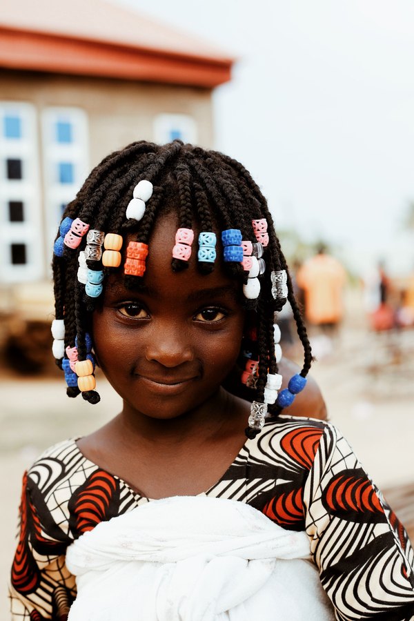 Little girl with braids and colorful beads
